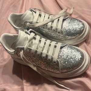 i’m selling my alexander mcqueens they are silver sparkly & white .